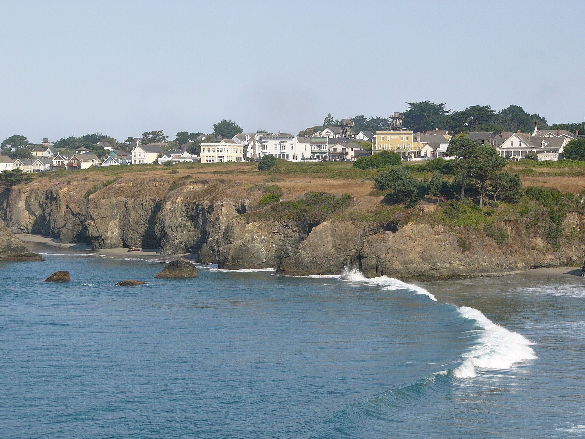 Mendocino village on a bluff above the Pacific, with water-tower cottages and a rocky shoreline